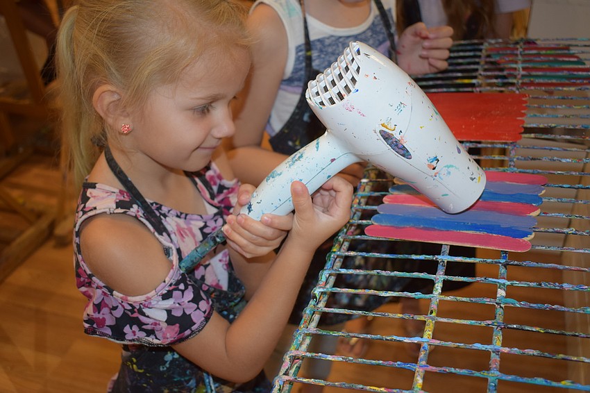 Lakewood Ranch 4-year-old MIsabelle Hayes dries the paint on her art project for her dad, Steve Hayes.