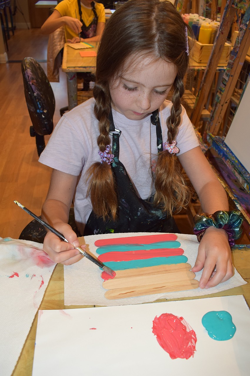 Lakewood Ranch 6-year-old Ella Van Vliet concentrates on painting her art project for her dad, Mike Van Vliet.