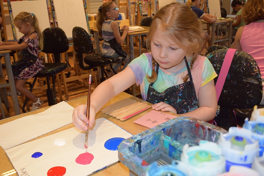 Lakewood Ranch 5-year-old Riley Truman dabs into some more paint to finish her project for her dad, Dan Truman.