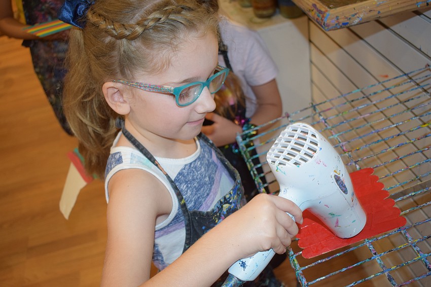 Lakewood Ranch 7-year-old Audrey Hayes finishes her project with some blow drying.