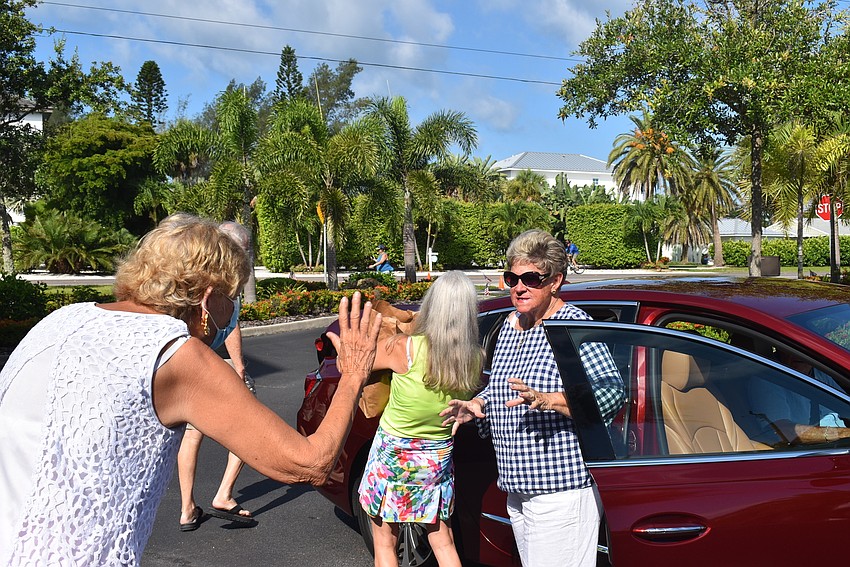 Beverly Sutton air-hugs Judy Smith.