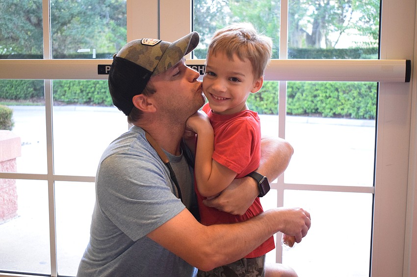 Tucker Short hugs and kisses his 5-year-old son Owen as a thank you for Owen giving him a donut to celebrate Father's Day. 