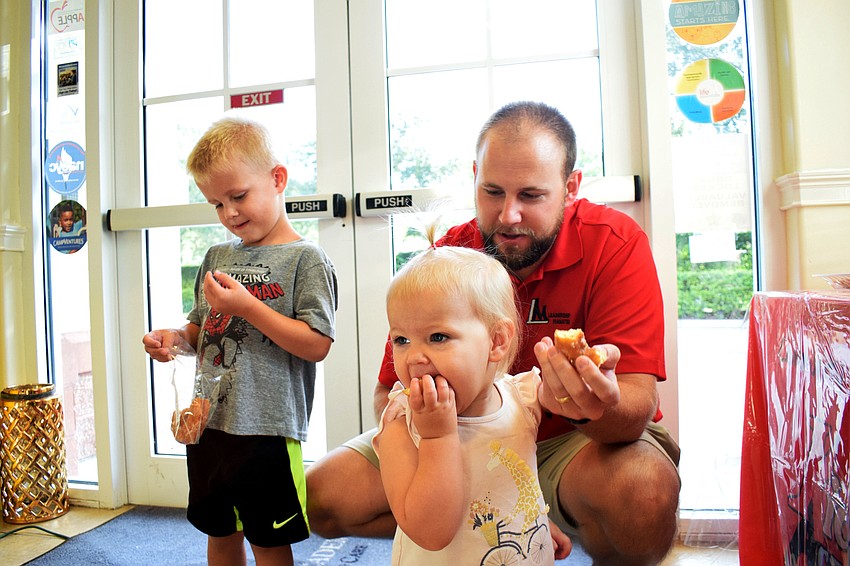James Allen shares his donut with his 4-year-old son JR and 1-year-old daughter Blake.