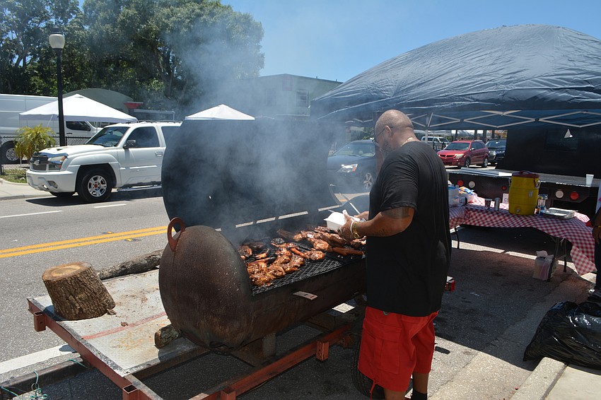 Clearance Robinson tends to meat on a grill along Dr. Martin Luther King Jr. Way.