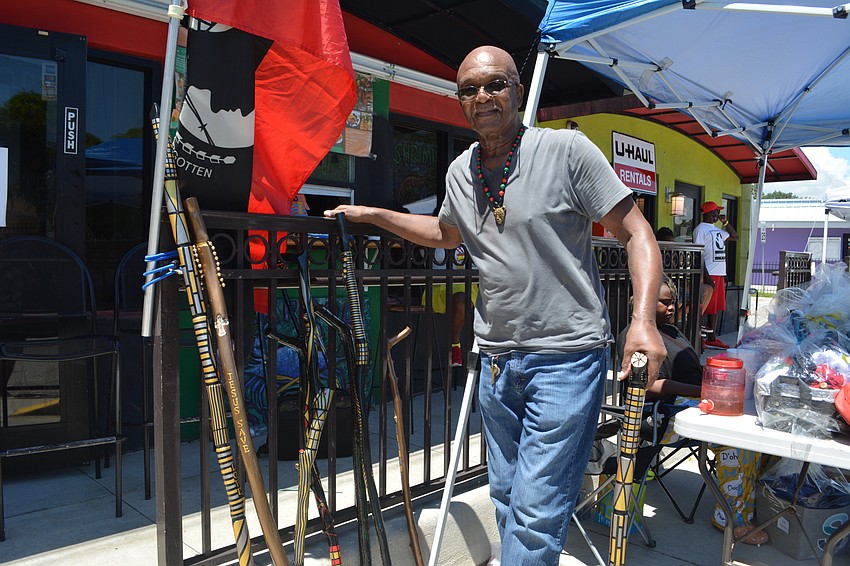 Chip Nelson shows off his hand-crafted canes and jewelry.