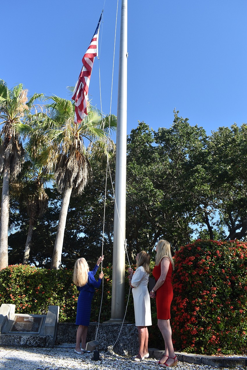 The flag makes its way up the pole.