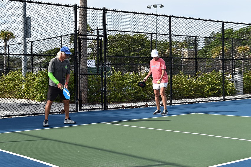 Nina Landgraf prepares to serve while Bob Gordon awaits  on June 22, 2020 at Bayfront Park in Longboat Key, Florida.