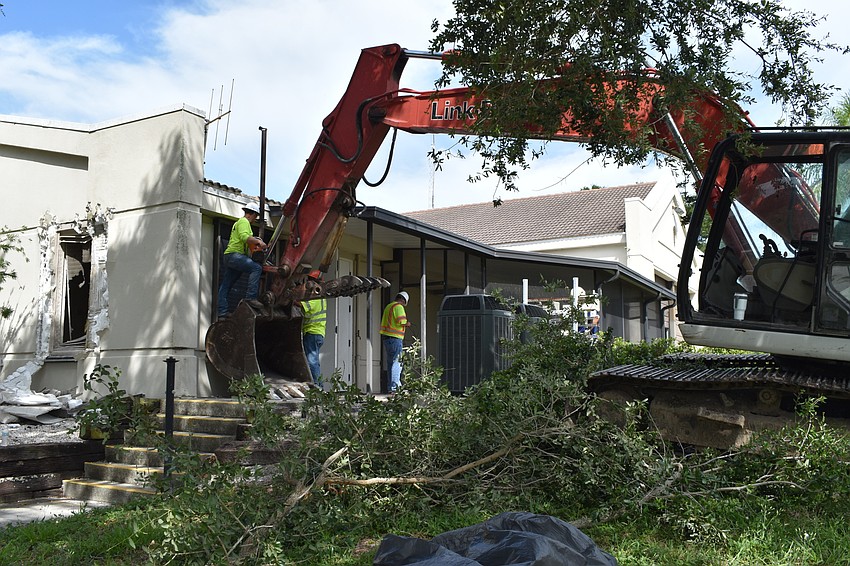 Crews work to tear down the east wall of the Longboat Key fire station on Monday, June 22, 2020.