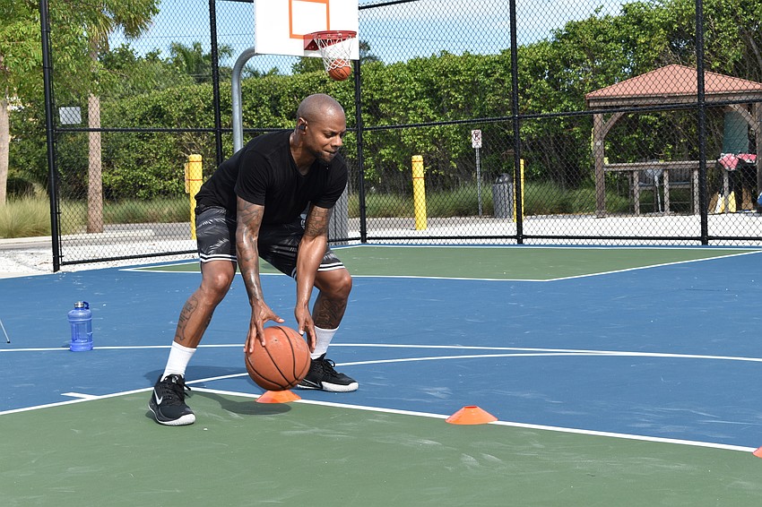 Tim Grant performs a dribbling drill for a client of his on Facebook Live. Grant uses a Bluetooth headset to communicate while livestreaming.