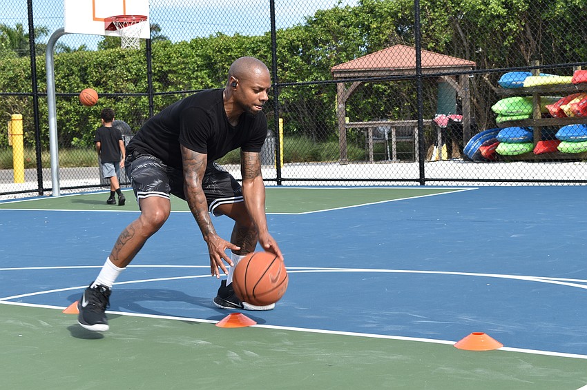 Tim Grant performs a dribbling drill for a client of his on Facebook Live. Grant uses a Bluetooth headset to communicate while livestreaming.