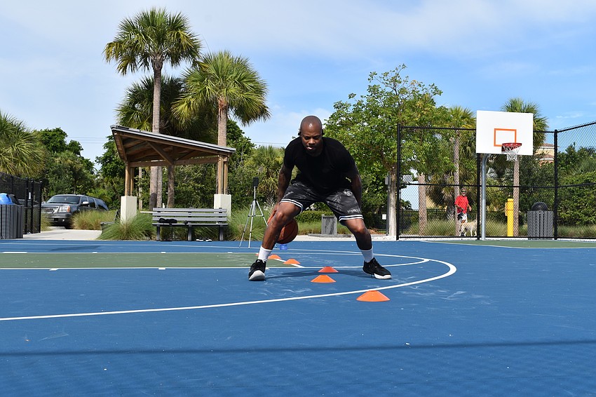 Tim Grant performs a dribbling drill for a client of his on Facebook Live. Grant uses a Bluetooth headset to communicate while livestreaming.