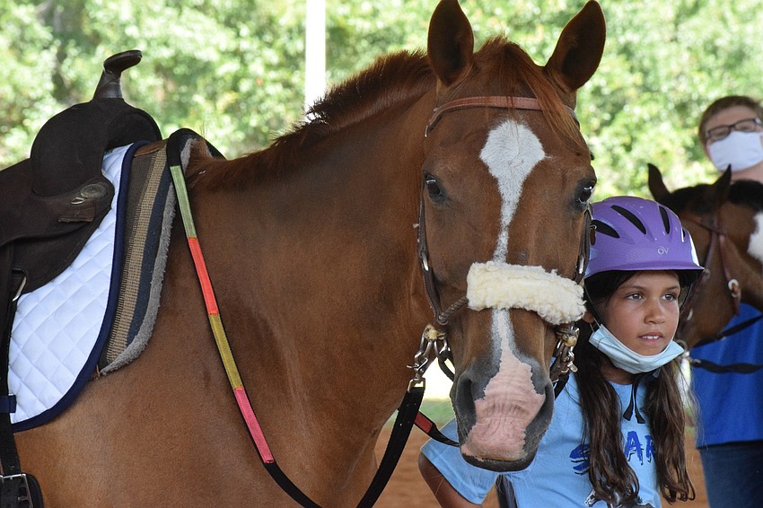 Cherokee is happy to be back with riders like camper Lilly Gerling, who is 9, since Sarasota-Manatee Association for Riding Therapy has been closed since April 1.