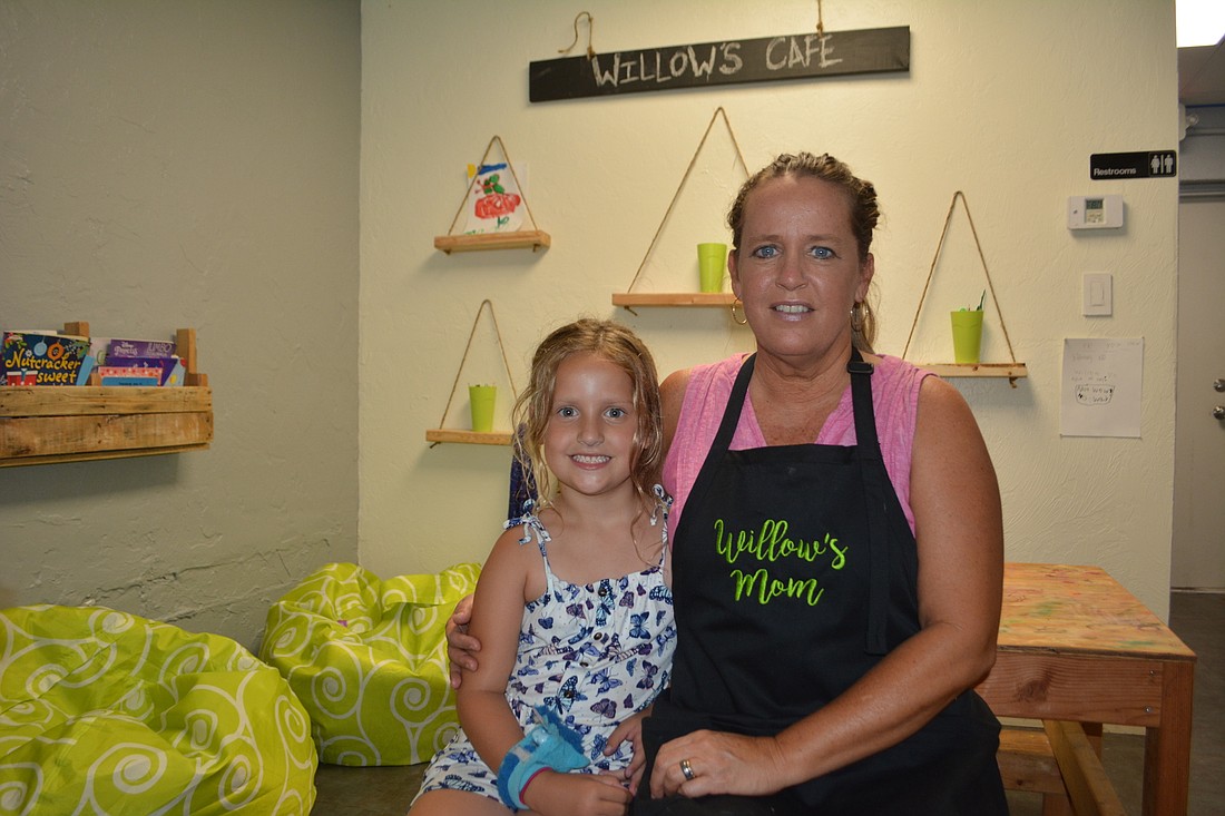 Willow and Whitney Willis sit in the children&#39;s area at the back of Willow&#39;s CafÃ©, a Rosemary District restaurant that opened in April.
