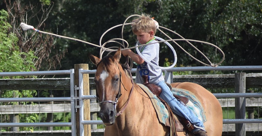 East County's Barrett Woodham, 7, is fit to be tied during the roping portion of the relay event.