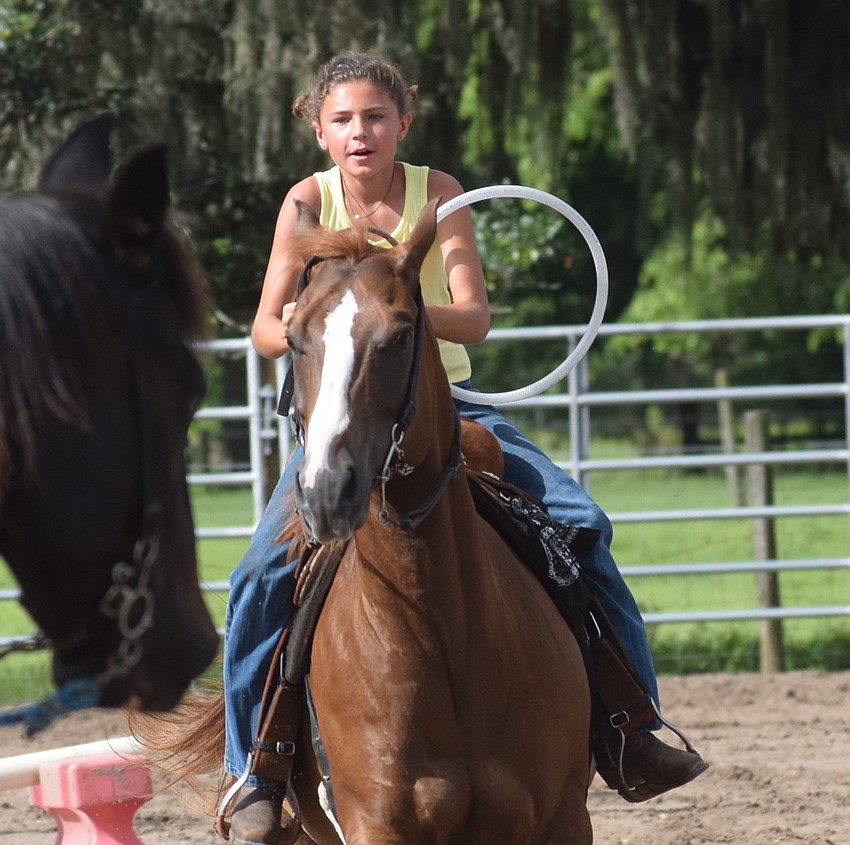 Sarasota's Brooklyn Martin, 9, gets ready to go over a jump in the relay race event.