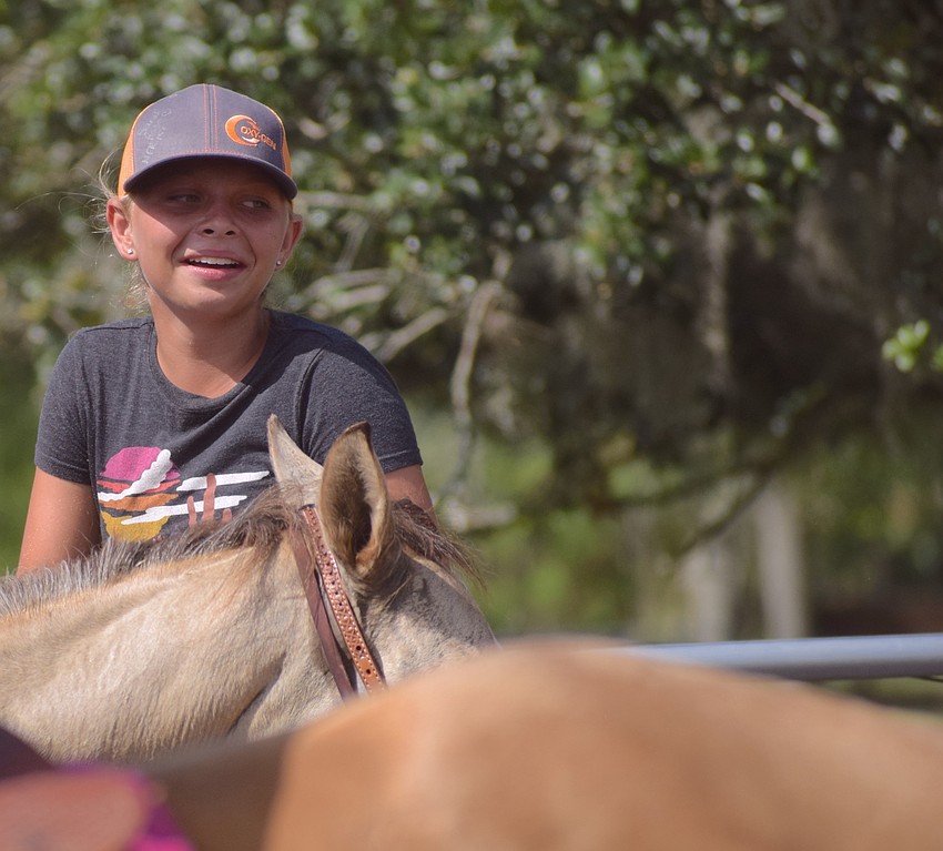 Sarasota's Julie Drymon, 12, finishes her event with a smile.