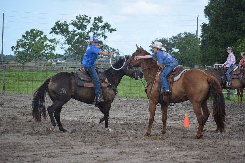 Chase Douglas and Preston Woodham hand off the ring in the relay event.