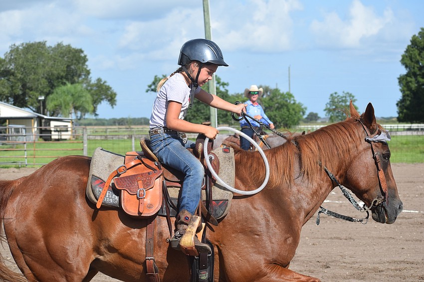Sarasota's Ellie Connours, 8, races to hand the ring off to a teammate during the relay race.