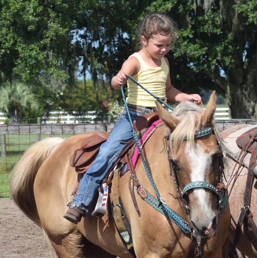 Paisley Mae Martin, 4, is the granddaughter of Sandy Johnson. She competed in the string race. She is riding her grandmother's longtime horse, Cutter.