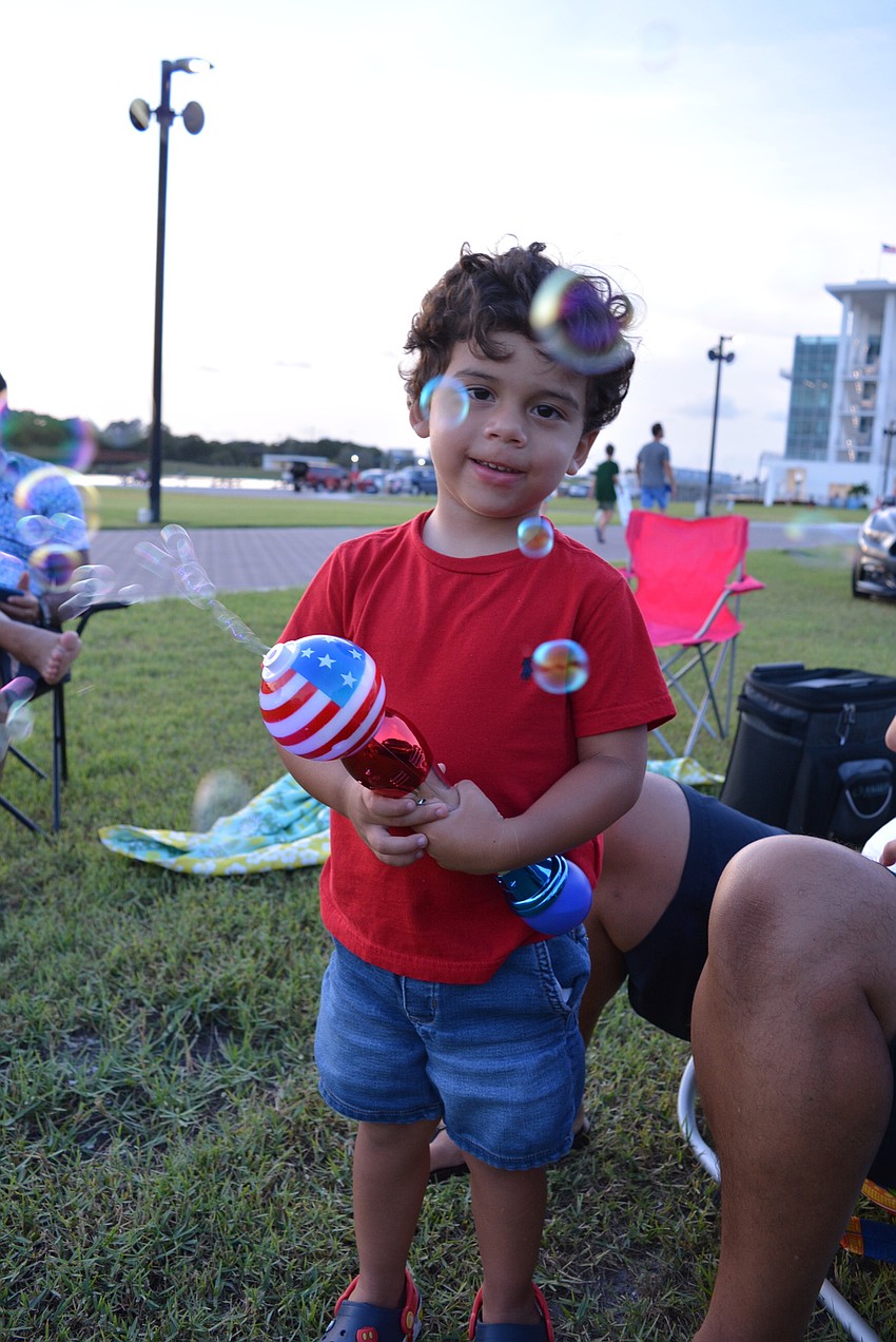 Two-year-old Orlando resident Benjamin Vargas enjoys watching bubbles stick to his car.