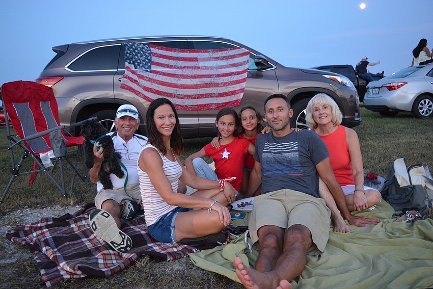 From left to right are: Dan Eli, Jen DiPasquale, Ava DiPasquale, Izzy DiPasquale, Derek DiPasquale and Sandi Eli, all of Mill Creek. They played a dice game as they waited for the show to begin.