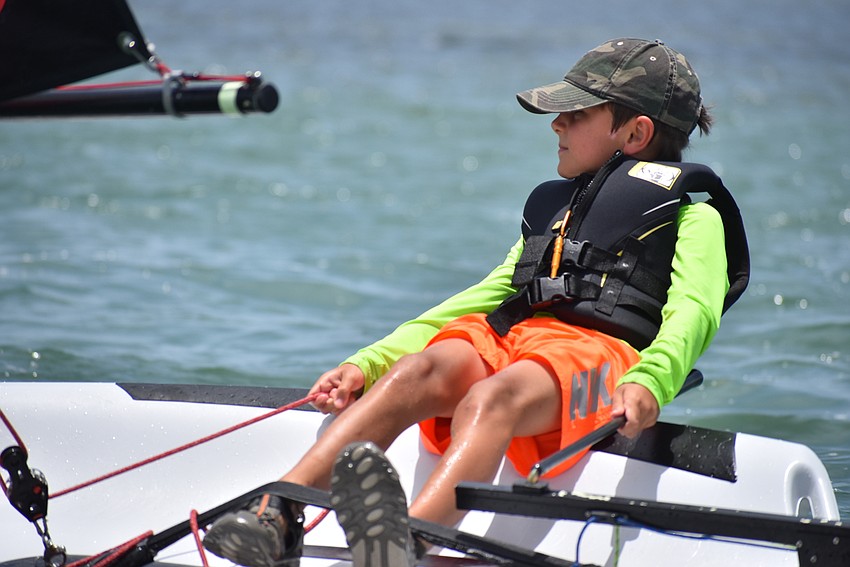Benjamin Vaughn leans back to control his boat.