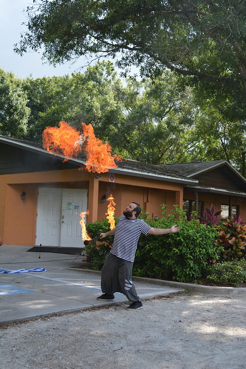 Trick Fire's Richard Deane blows flames roof high, much to the amazement of the children.