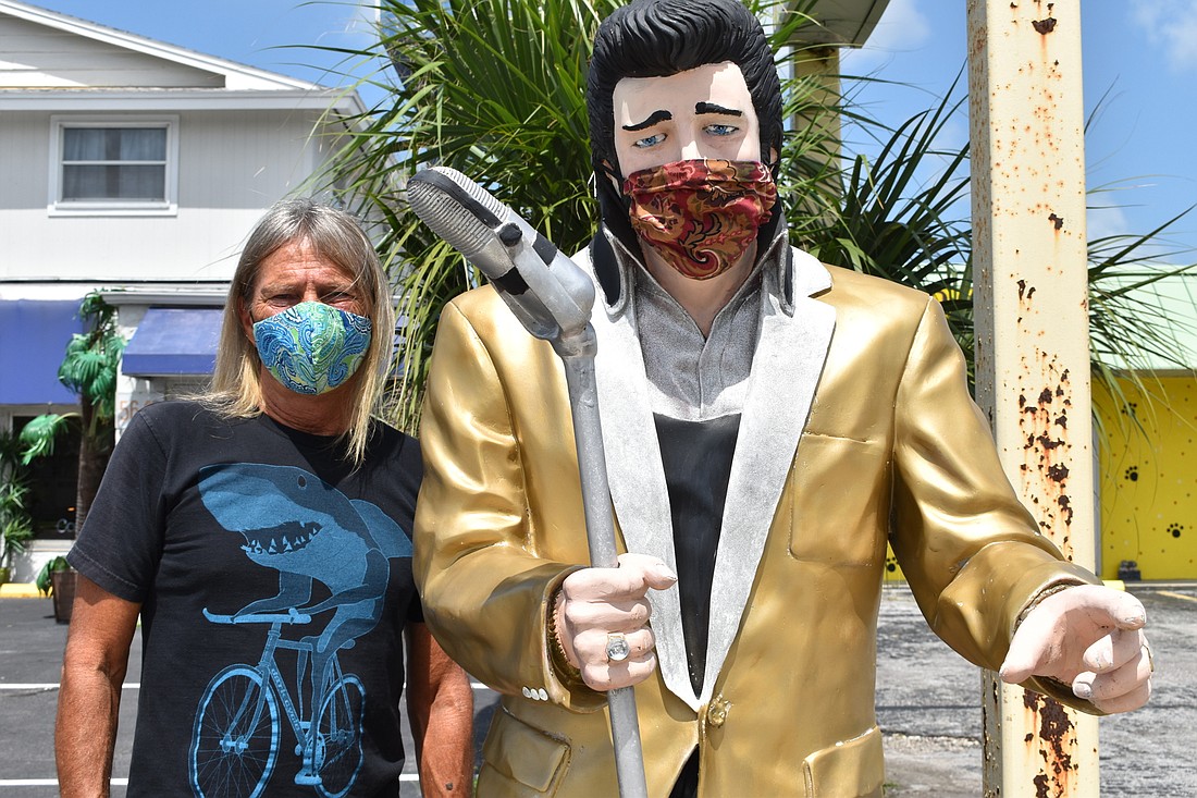The Blue Heirloom volunteer Martin Sperber stands next to the Elvis statue that stands outside of the thrift store at 5650 Swift Road in Sarasota, Florida.