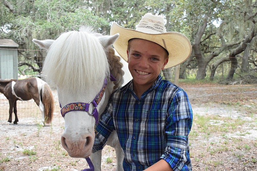 William Davis, a 12-year-old camper, loves his mini horse Prince.