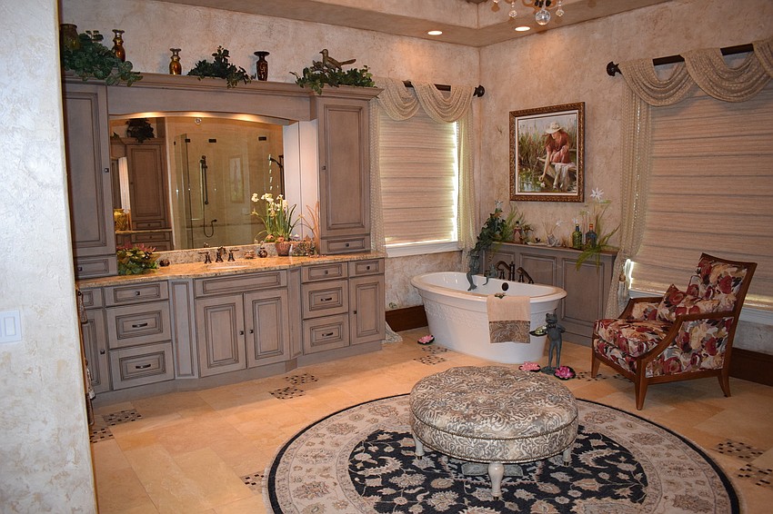 The master bathroom has plenty of sitting space, whether in or out of the tub. Photo by Jay Heater