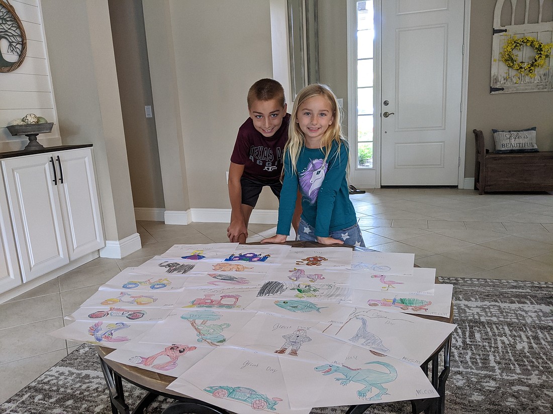 Colton and Kinley McGill want to spread happiness throughout their community with their drawings. â€œItâ€™s kind of like trick-or-treat, but we bring the treat to the people," Colton McGill says. Courtesy photo.