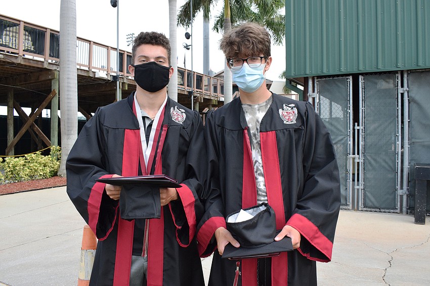 Michael Gagnon and Patrick Gajowczyk prepare to enter the baseball stadium for their graduation ceremony.