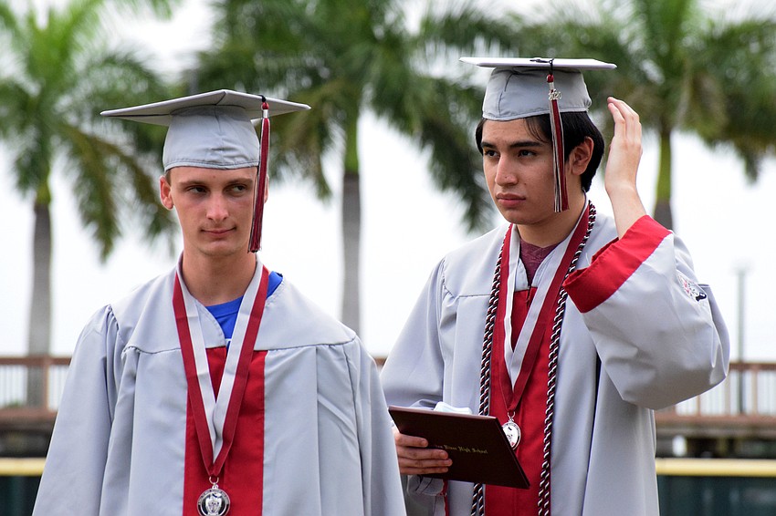 Aaron Patmor and Jovany Perez move their tassels from the right to the left signifying their graduation from Braden River High School.