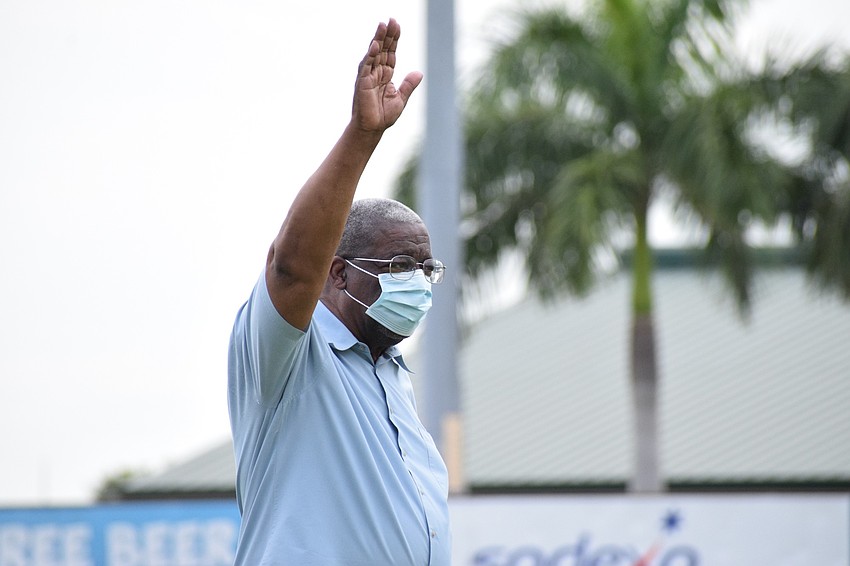 School board member the Rev. James Golden waves to the crowd of families at Braden River High School's graduation.