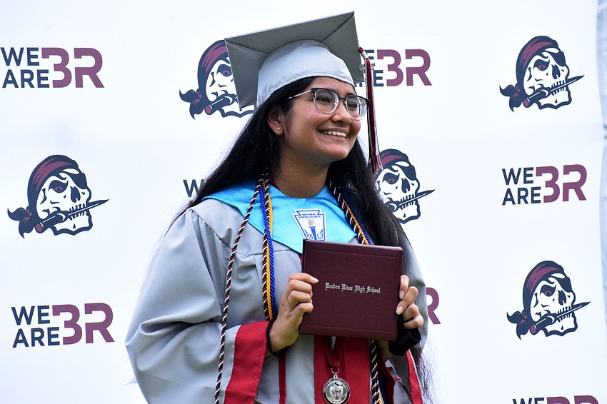 Khushbu Patel excitedly accepts her diploma.