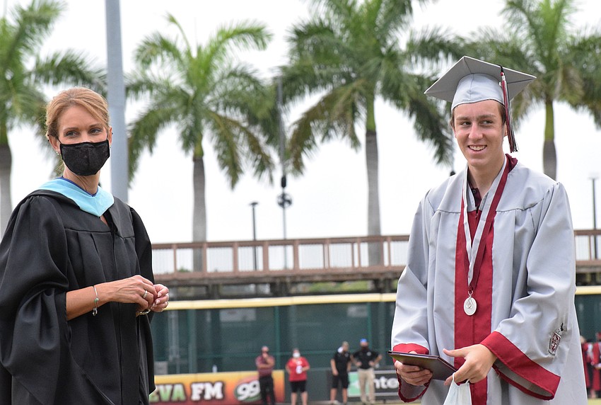 Sharon Scarbrough, principal of Braden River High School, chats with graduate Aiden Smith.