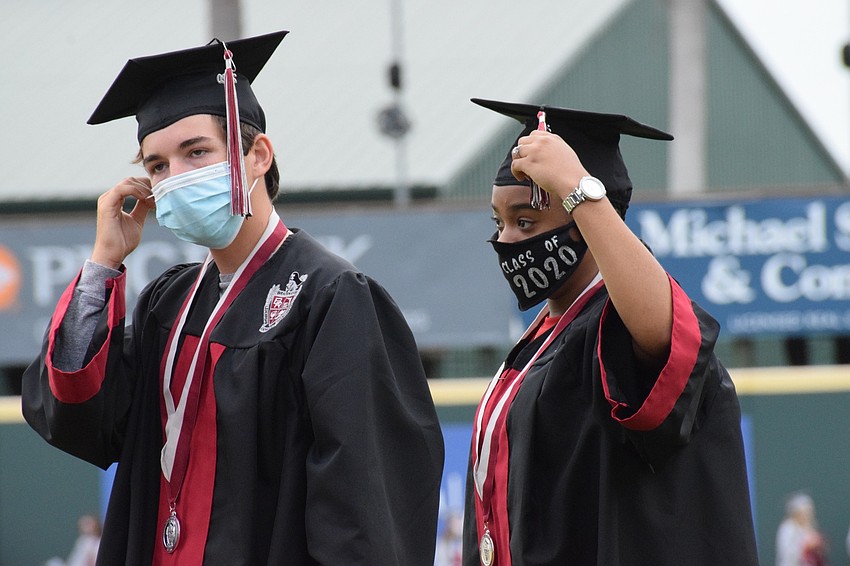 Brendan Caruso and Kayla Banks move their tassel from the right to the left signifying their graduation.