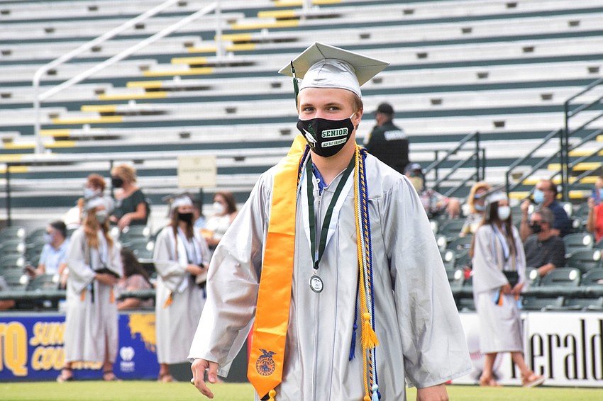 JT Girman wears a stole, medial and cords to represent his accomplishments.