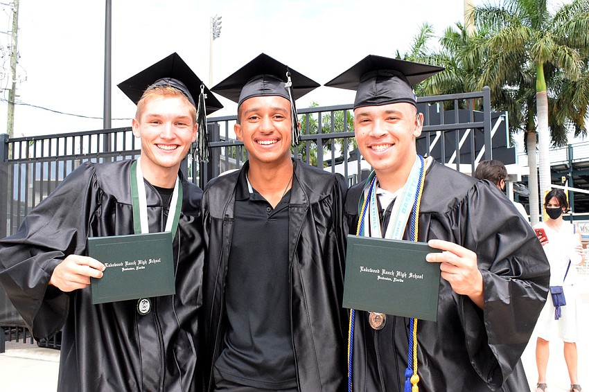 Nathan Pease, Keon Buckley and Jaden Jones celebrate their graduation after the ceremony.