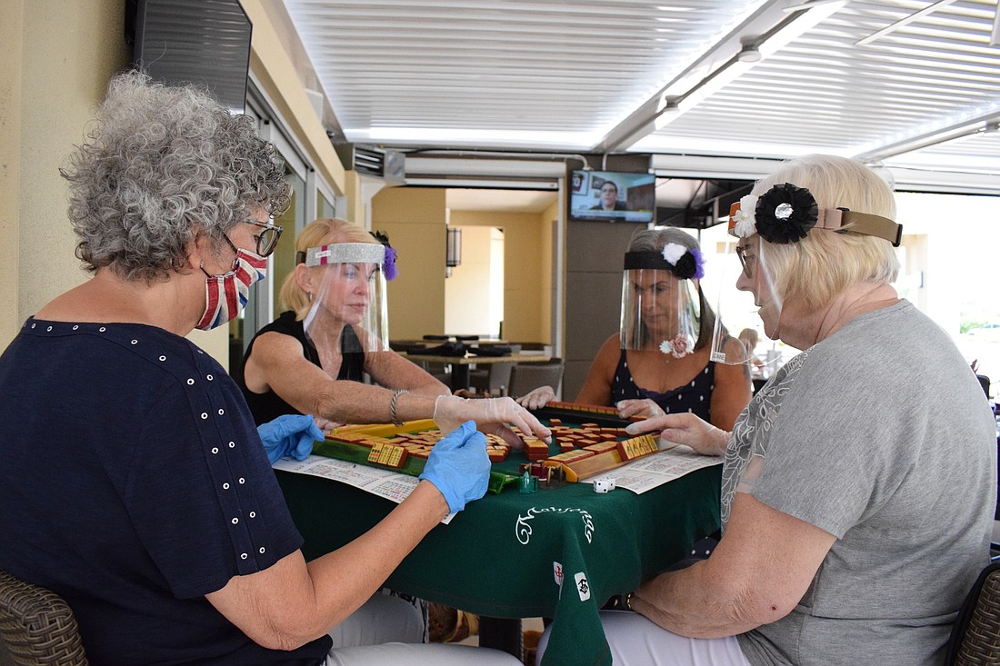 Helene Levin, Sallie Feldman, Bobbi Blackman and Suzanne Weitz play mahjong at the Grove.