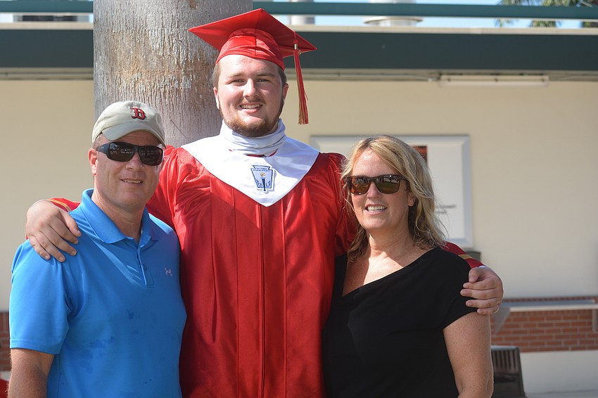 Keith Marshall, Nathan Marshall and Kimber Marshall celebrate Nathan's graduation from Cardinal Mooney High.