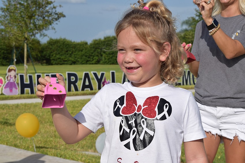 Charlotte Wells rings a cowbell as the parade continues.