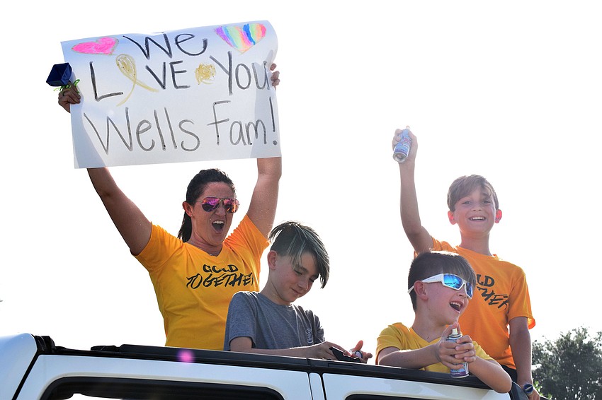 Cristina McCrone cheers with her sons Christopher and Lucas McCrone and Landen Chandler. 