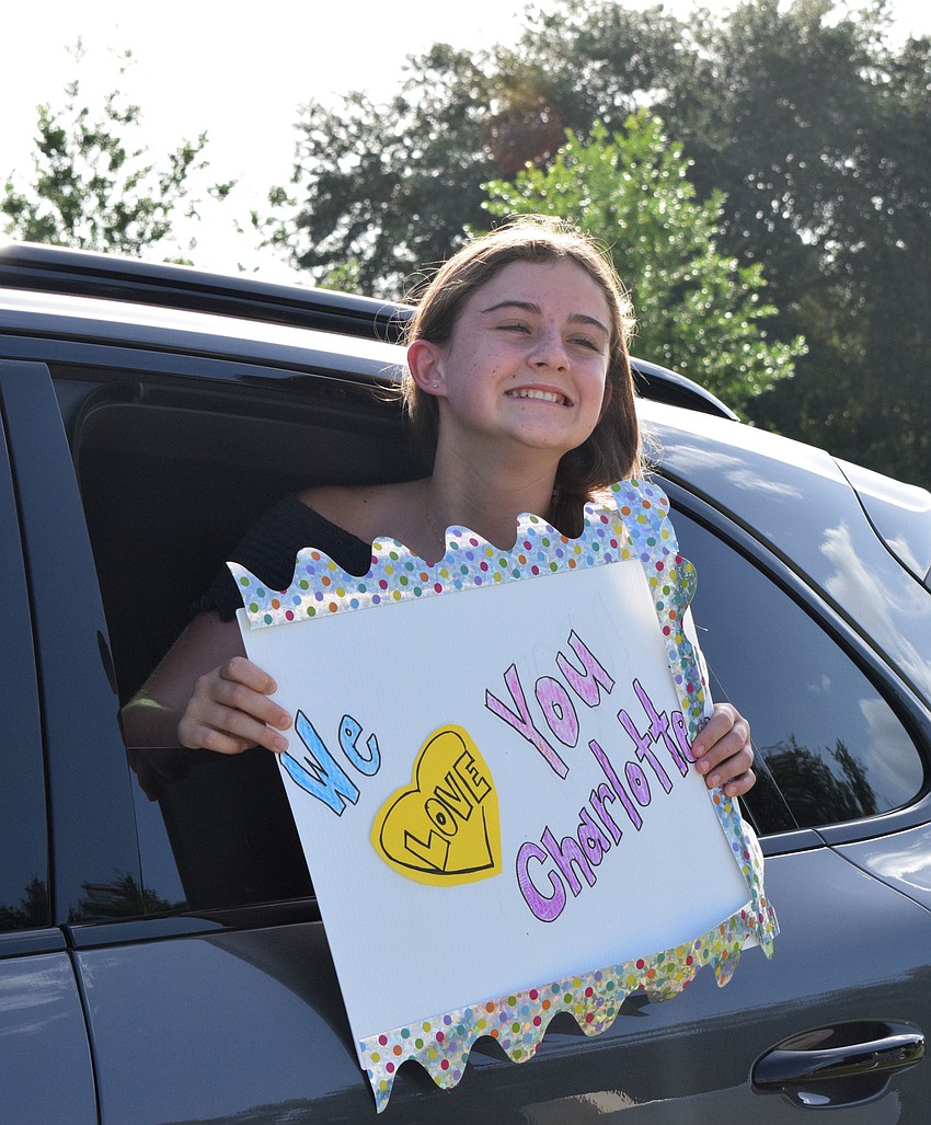 Eva Dyer holds up a sign while going through the parade.