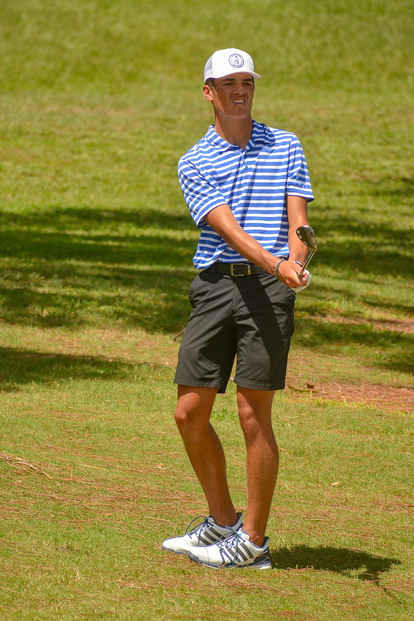 Russell Aetonu, who attends Riverview High, hits a shot from the rough onto the green.