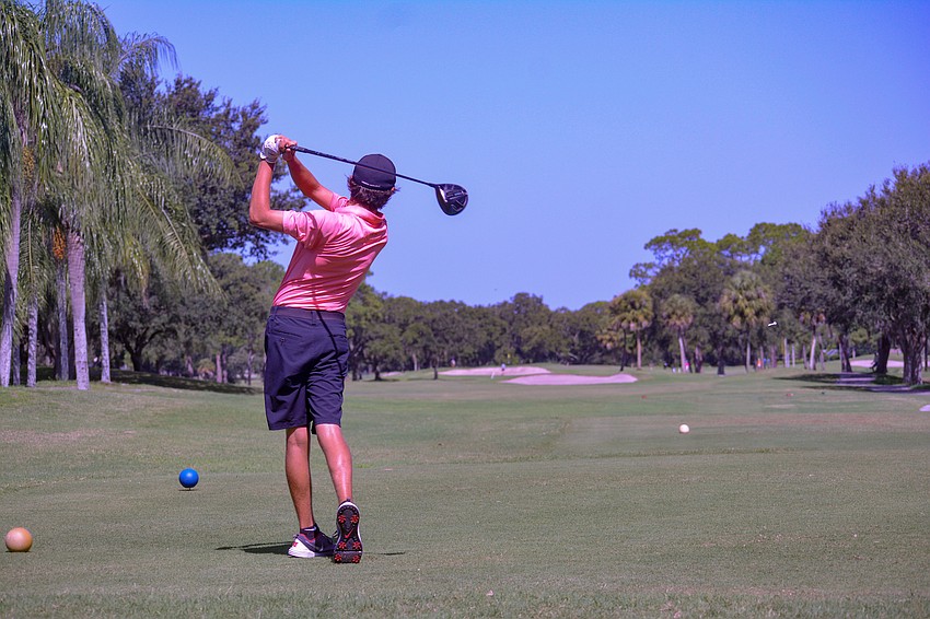 Logan Veith tees off on hole No. 1 at Palm Aire Country Club.