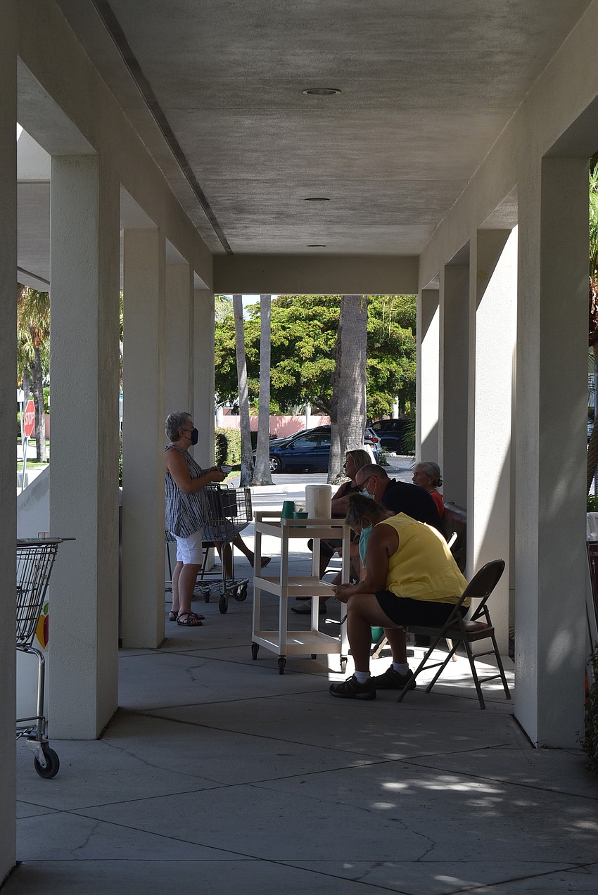 Volunteers gathered in the shade between donations.