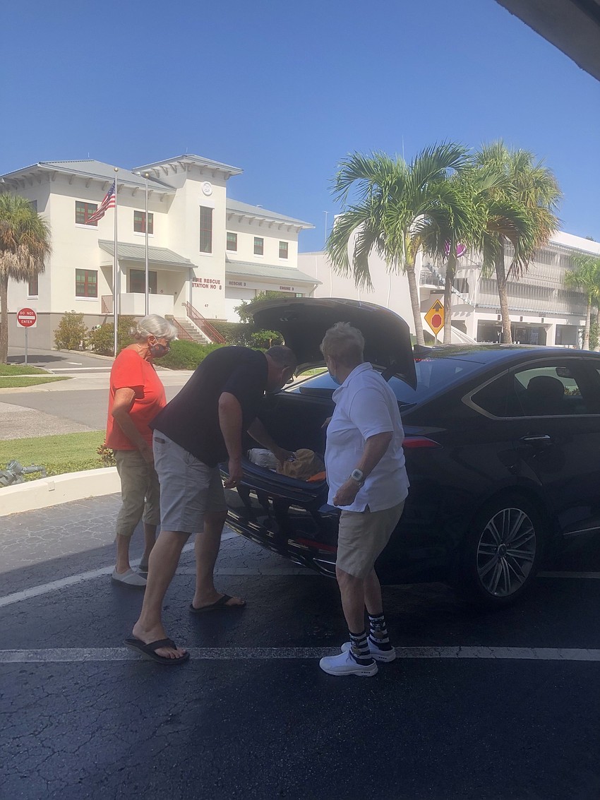 Volunteers unloaded the cars quickly and sent the donors on their way.