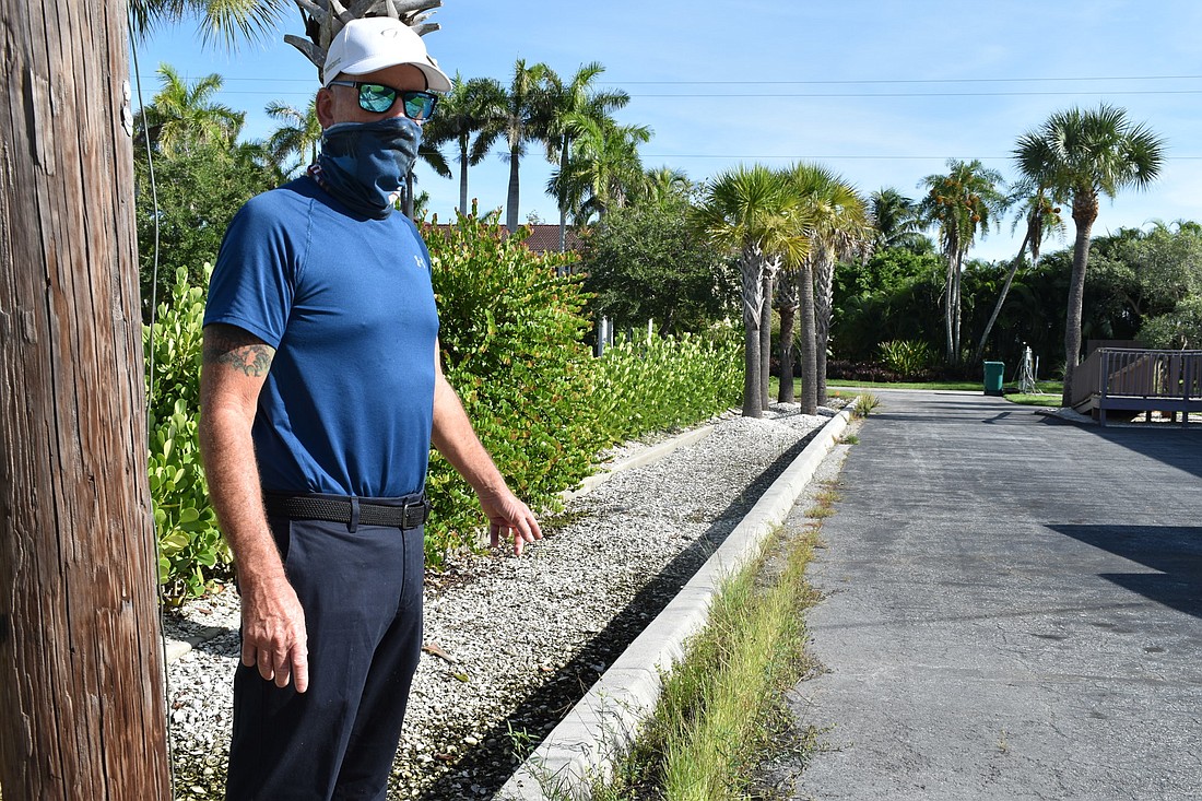 Ross Toussaint is pictured near the bioswale between his property and Christ Church of Longboat Key.