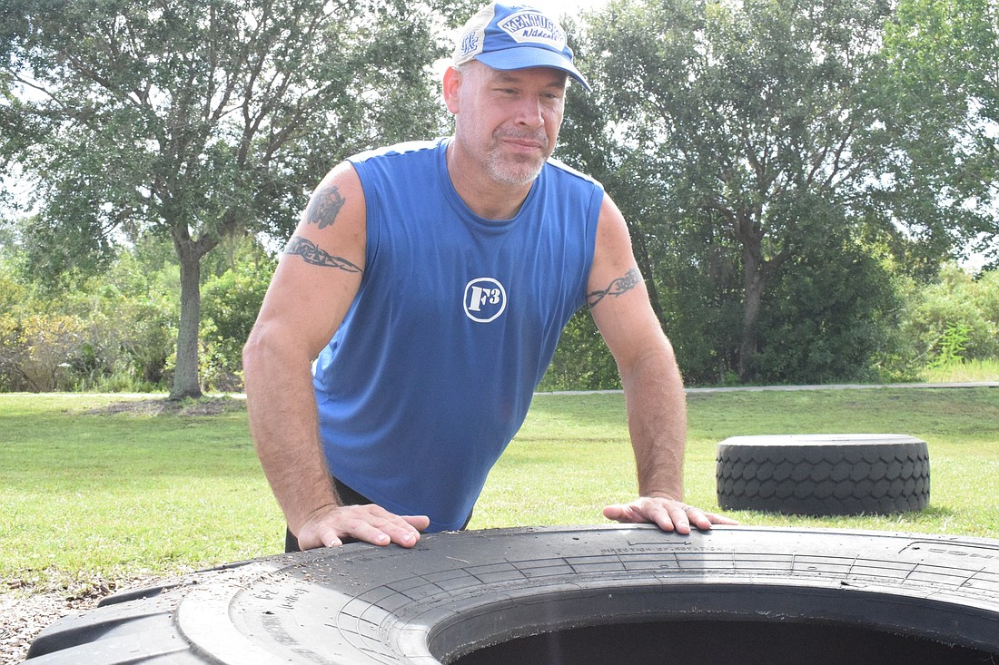 Lesley Aulds does push ups on a giant tire at Greenbrook&#39;s Adventure Park.